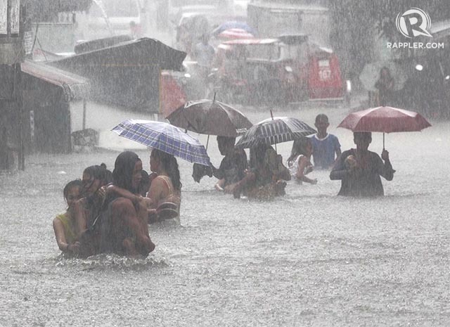 residents crossing flood water
